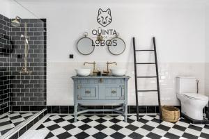a bathroom with a blue cabinet and two sinks and a toilet at Quinta dos Lobos Boutique Hotel - Nature Experience in Sintra +62 photos