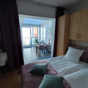 a bedroom with a bed and a dining room at Apartment Villa Ksenija in Ostend