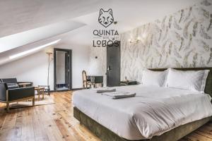 a bedroom with a king sized bed and a wall mural at Quinta dos Lobos Boutique Hotel - Nature Experience in Sintra