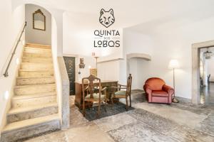 a room with a staircase and a table and chairs at Quinta dos Lobos Boutique Hotel - Nature Experience in Sintra