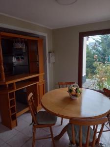 a kitchen with a table with a bowl of fruit on it at BE MAISON USHUAIA in Ushuaia