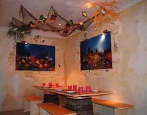 een eetkamer met een tafel en enkele rode kaarsen bij Smileys Kinderhotel in Trebesing