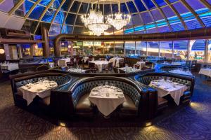 a dining room with tables and chandeliers at Plaza Hotel & Casino in Las Vegas