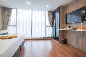 a hotel room with a bed and some windows at Bridge Lakeside Room For Rent Hanoi in Hanoi