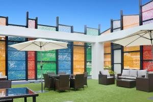 a restaurant with tables and chairs and large windows at Crowne Plaza Residences Port Moresby, an IHG Hotel in Port Moresby