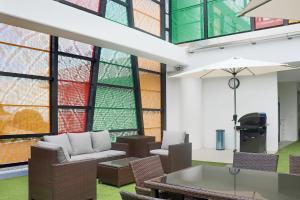 a living room with chairs and a table and windows at Crowne Plaza Residences Port Moresby, an IHG Hotel in Port Moresby