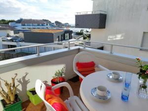 - Balcón con mesa blanca y sillas en Studio with partial sea views in the popular seaside resort of Benodet en Bénodet