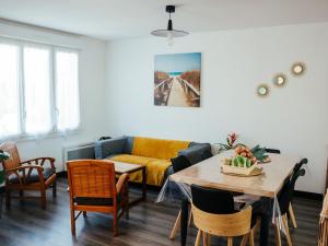 a living room with a couch and a table and chairs at Comfortable holiday home with a spacious terrace area near the sea in Sibiril