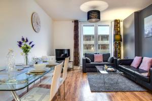 a living room with a glass table and a couch at Inners City Apartments -On Suites in Birmingham