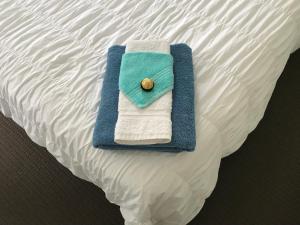 a towel is sitting on top of a bed at Jennie's In Whitianga in Whitianga
