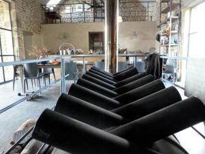 a group of black chairs in a room with a table at Luxurious Farmhouse in Braize in Coust
