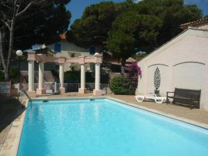 a swimming pool with a gazebo next to a house at Villa in Sainte-Maxime near La Nartelle Beach in La Nartelle
