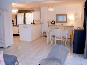 a kitchen and dining room with a table and chairs at Beachfront holiday home, Guisseny in Guissény