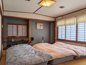 Ένα ή περισσότερα κρεβάτια σε δωμάτιο στο Ryokan Kibun