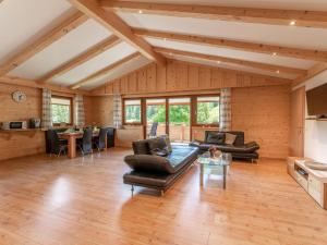 a large living room with wooden walls and wooden floors at Hoellerhof Luxe in Forstau