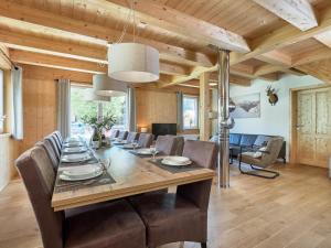 a dining room with a long table and chairs at Murtal Chalet in Sankt Michael im Lungau