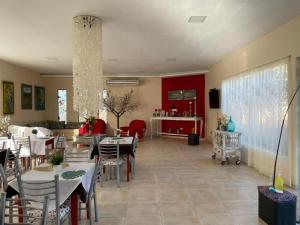 a dining room with tables and chairs and a room with at Apart Hotel Las Violetas in Candelaria