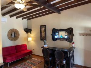 sala de estar con sofá rojo y espejo en Estancita Elena en Valle de Guadalupe