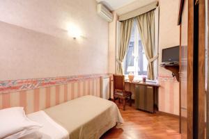 una camera d'albergo con 2 letti, una scrivania e una TV di Hotel St. Moritz a Roma