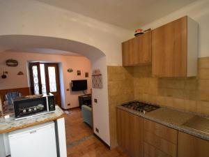 een keuken met houten kasten en een aanrecht bij Cozy Holiday Home with Small Garden in Trarego Piedmont in Trarego