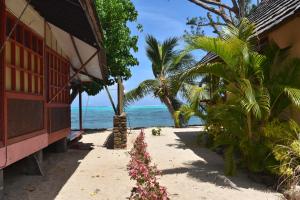 a building on the beach next to the ocean at Fare Aute Beach in Vaianae