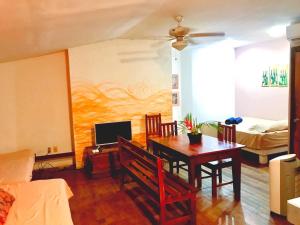 a living room with a dining room table and a bedroom at Beautiful Second Story Apartment 202 Next to Playa Flamingo in Playa Flamingo