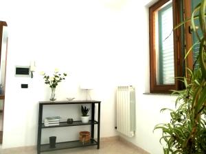 a black shelf in a room with a radiator at Bright apartment a few km from the sea in Minervino di Lecce