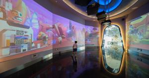 a person standing in front of a large painting on a wall at Grande Centre Point Space Pattaya in North Pattaya