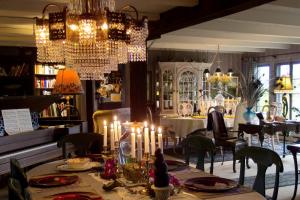 a dining room with a table with candles on it at Le Petit Clocher Gite Touristique B & B in Saint-Sauveur-des-Monts