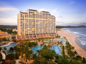 a hotel with a view of the beach and the ocean at Holiday Inn Resort Ho Tram Beach by IHG in Ho Tram