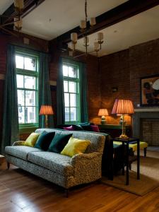 a living room with a couch and a table at The Observatory Hotel Christchurch in Christchurch