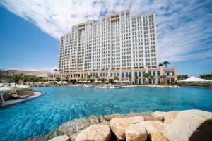 a hotel with a large pool in front of a building at Holiday Inn Resort Ho Tram Beach by IHG in Ho Tram