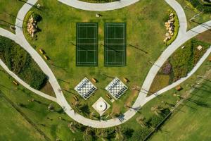 an overhead view of a park with three wind turbines at Holiday Inn Resort Ho Tram Beach by IHG in Ho Tram