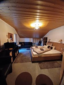 a bedroom with two beds and a wooden ceiling at Gästehaus Susanne in Oberstaufen