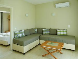a living room with a couch and a coffee table at Cosmos Apartments in Vasiliki