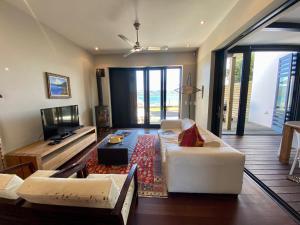 a living room with a couch and a tv at TH39 Thesen Islands in Knysna