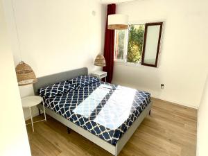 a bedroom with a bed and a window at Naked House Sardinia in Bari Sardo