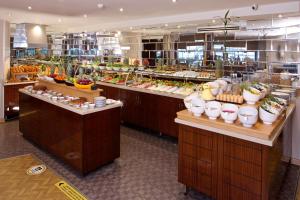 a buffet line in a restaurant with fruits and vegetables at Mosaic Hotel Old City -Special Category in Istanbul