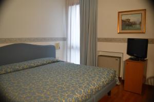 Postel nebo postele na pokoji v ubytování Hotel Sagittario
