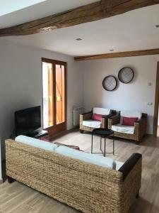 a living room with a couch and a tv at CasaCo Llessui in Llesúy