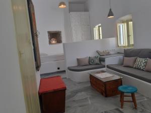 a living room with a couch and a table at Villa Meltemi in Arnados