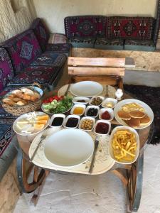 a table with plates and bowls of food on it at CAPPADOCİA ST.NİNO'S GARDEN in Ortahisar