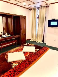 a room with a bed with two laptops on it at Hotel Silver Falls - Nuwara Eliya in Nuwara Eliya