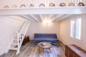 a room with a bed and a stair case at Annika's Family House in Karpathos