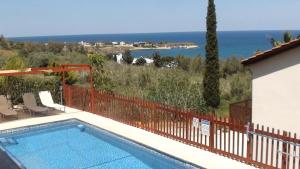 a swimming pool with a view of the ocean at Pomos Harbourbiew Villa in Pomos