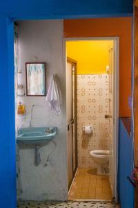 a bathroom with a sink and a toilet at Casa Los Patios in Jericó