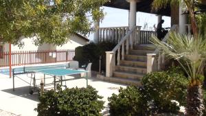 a patio with a ping pong table and stairs at Pomos Harbourbiew Villa in Pomos
