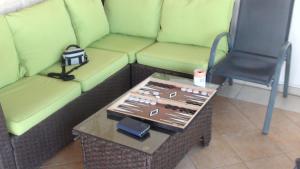 a green couch with a table and a chair at Pomos Harbourbiew Villa in Pomos