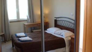a bedroom with a bed with two towels on it at Pomos Harbourbiew Villa in Pomos