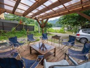 a group of chairs and a table on a patio at Five Peaks Jigokudani in Shiga Kogen